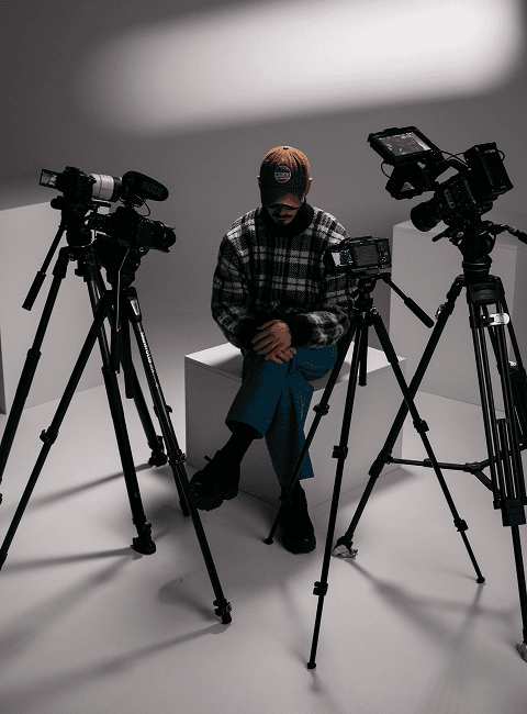 A picture of Nikalas Nedyalkov sitting with cameras pointing towards him from the shooting of his interview.