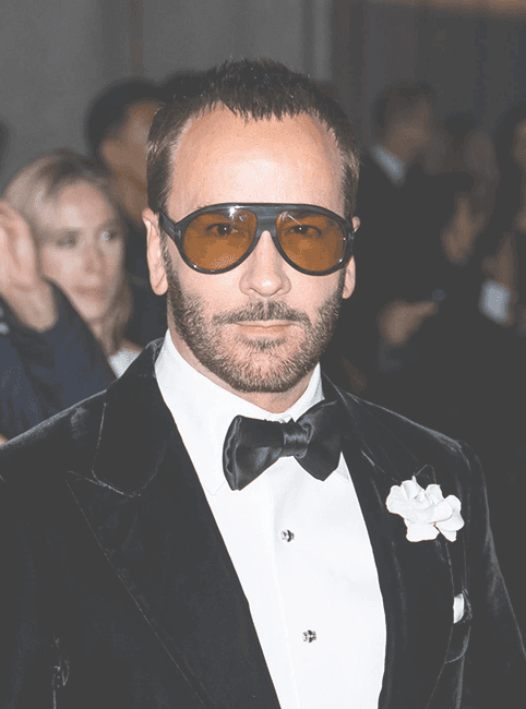 A picture of Tom Ford wearing a tuxedo looking at the camera.
