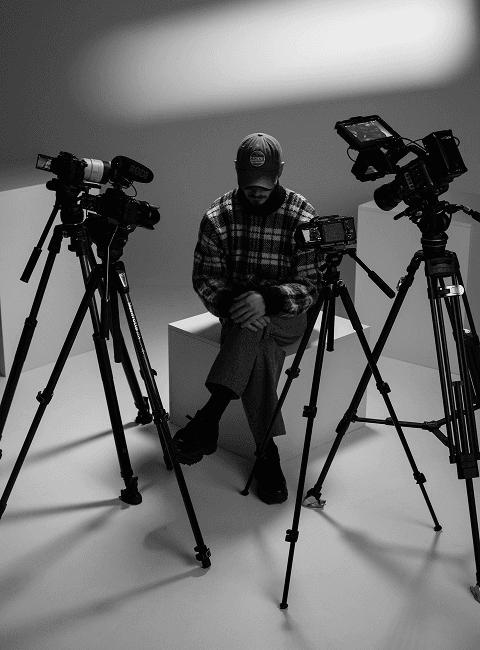 A picture of Nikalas Nedyalkov sitting with cameras pointing towards him from the shooting of his interview.