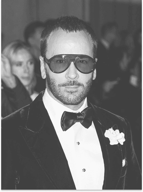 A picture of Tom Ford wearing a tuxedo looking at the camera.